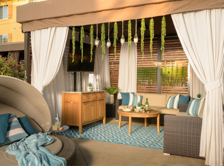 View of beautiful pool cabana with a daybed and seating area