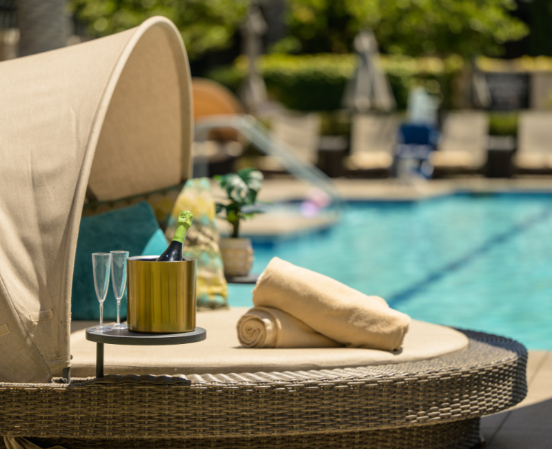 Daybed by the pool with two towels on top