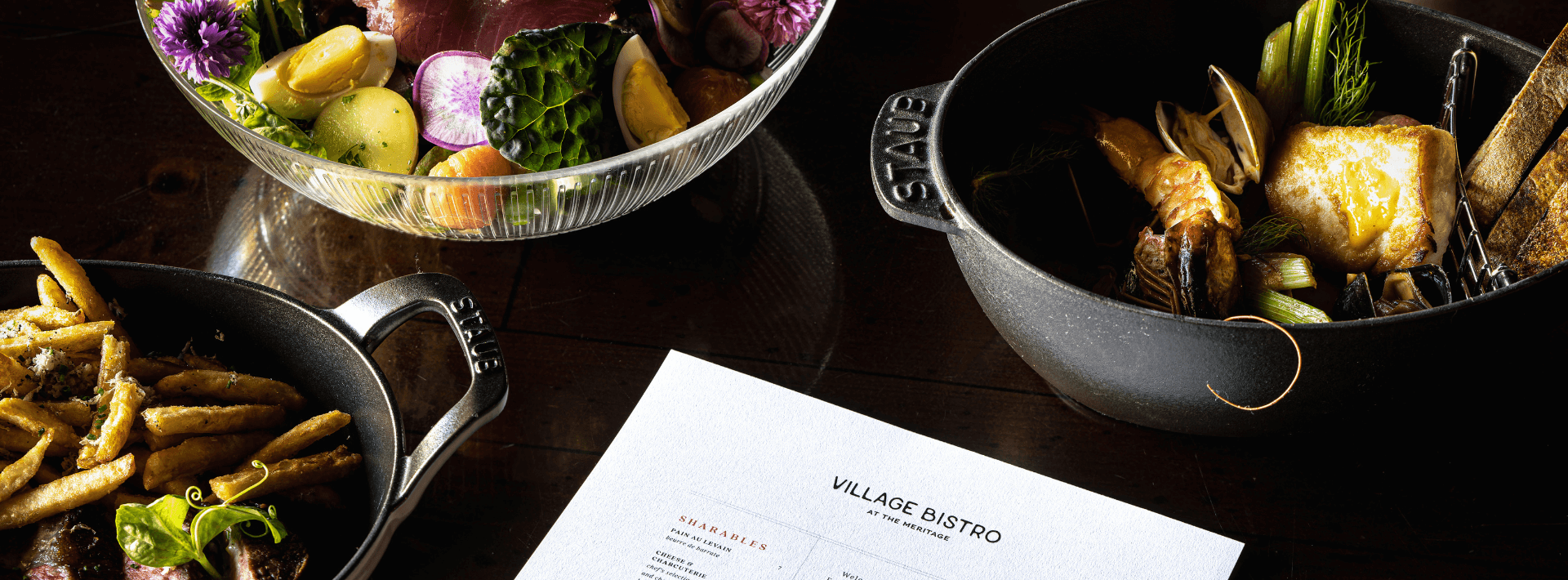 village bistro menu surrounded by three plates