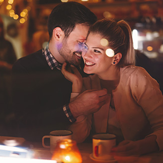 Couple having coffee and embracing each other