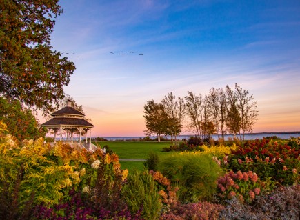 a garden next to the with a gazebo next to the ocean