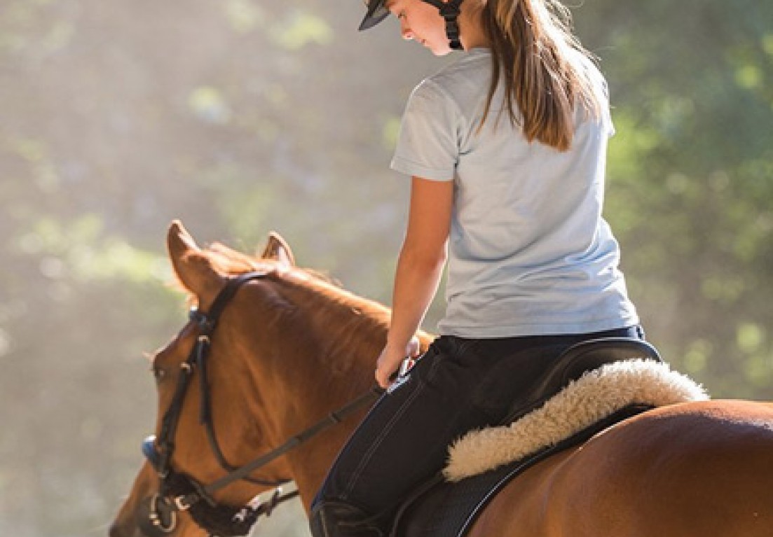 a woman riding a horse