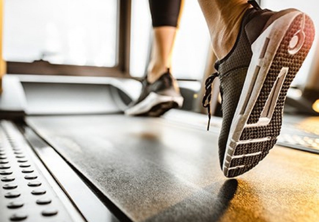 close up view of a woman's feet on a treadmill