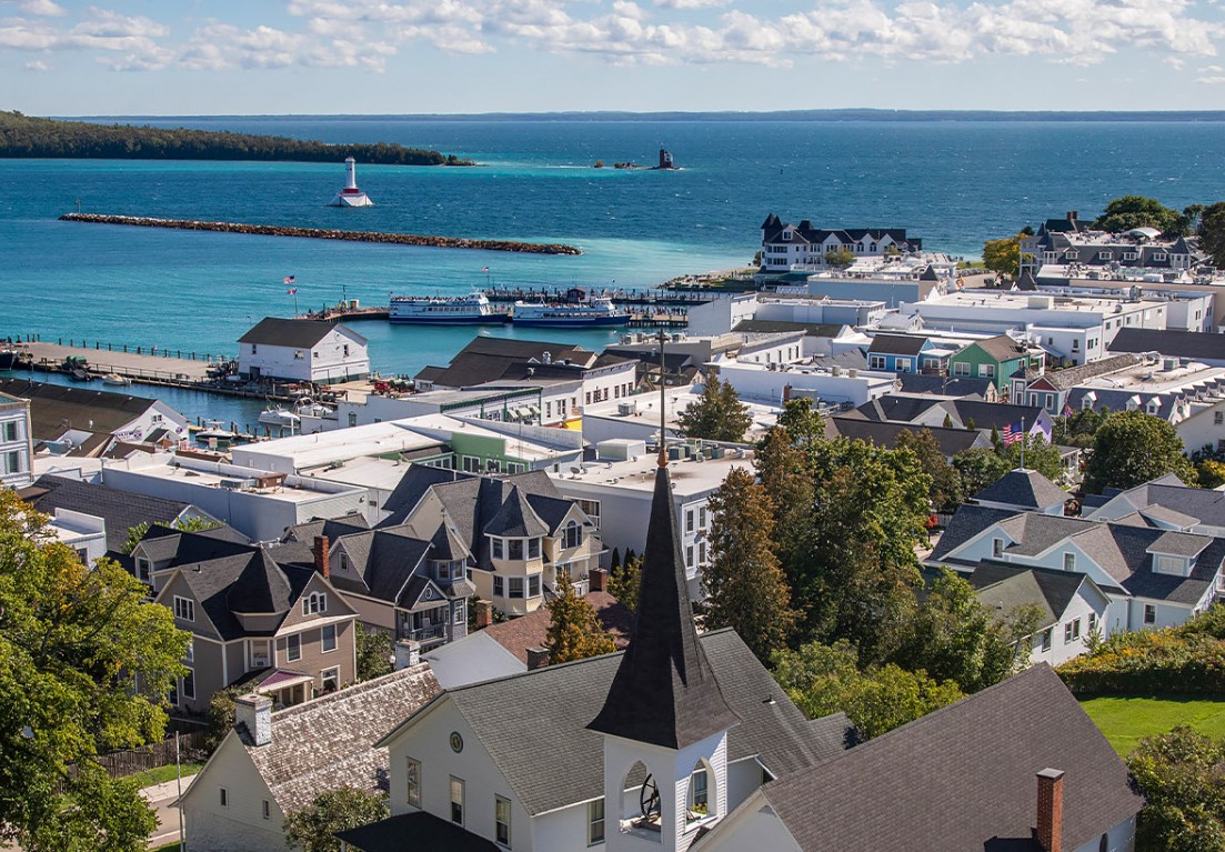 a view of many buildings near the ocean