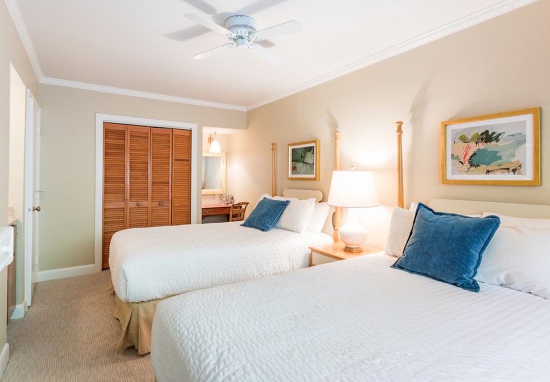 2 full beds in the family suite with blue pillows