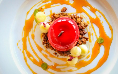 close up of a delicious dish with an apple in the center and sauce surrounding it