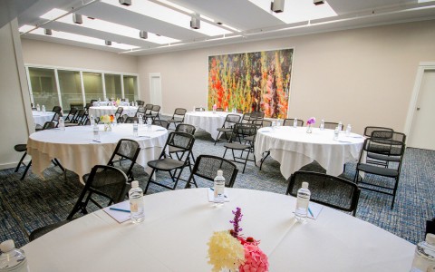meeting venue with round tables with table cloths 