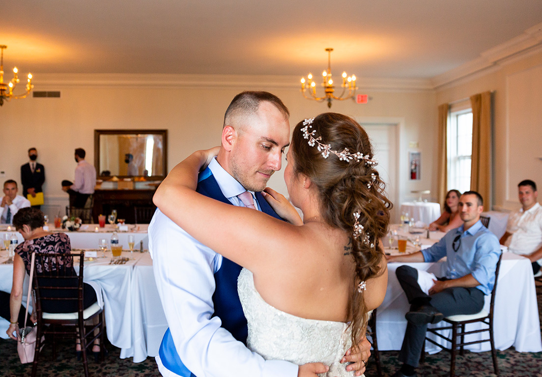 close up of a bride and groom embracing at a wedding reception
