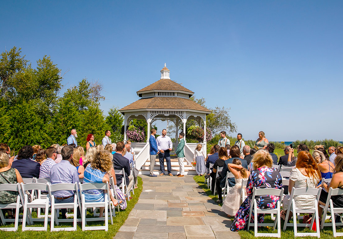 wedding ceremony with the grooms at the front