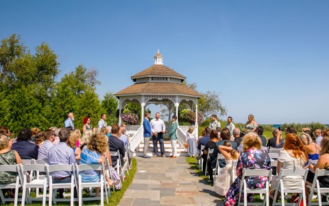 a group of people sitting in front of a gazebo