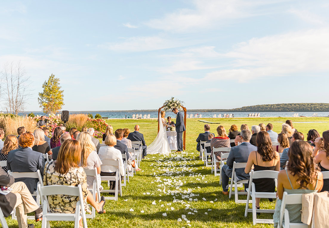 outdoor wedding with bride and groom at the front