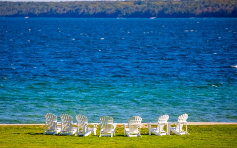 lawn chairs on the lawn facing the lake