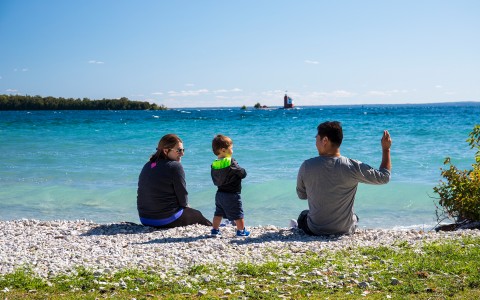 family sitting looking at the beach 