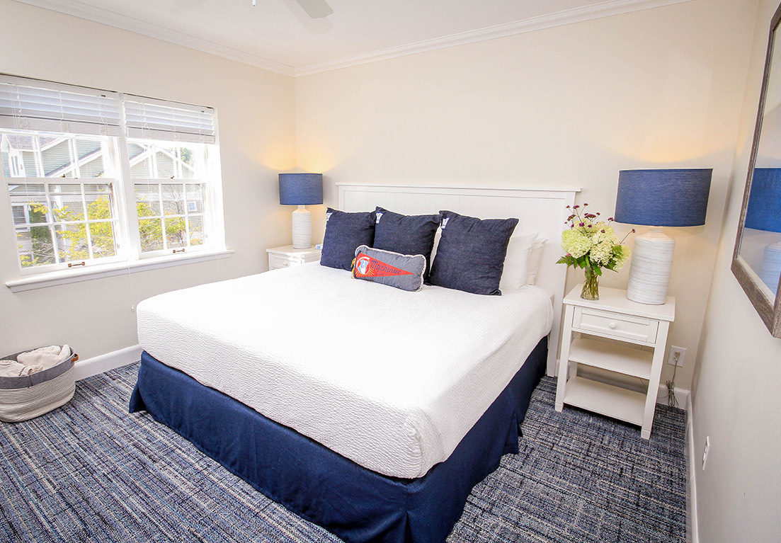 view of a hotel room with two night stands and lamps