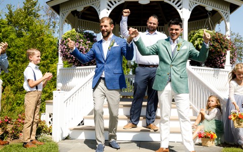 a group of people standing in front of a gazebo