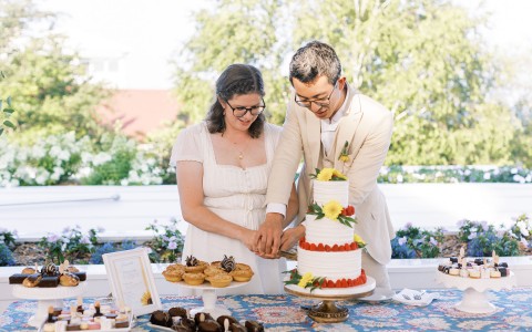 a man and women cutting a cake