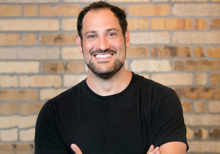 man with black shirt smiling