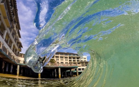 wave with hotel on background 
