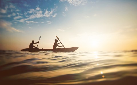 couple kayaking on water 