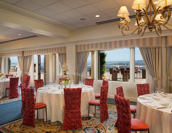 wedding reception set up with round tables with ocean view