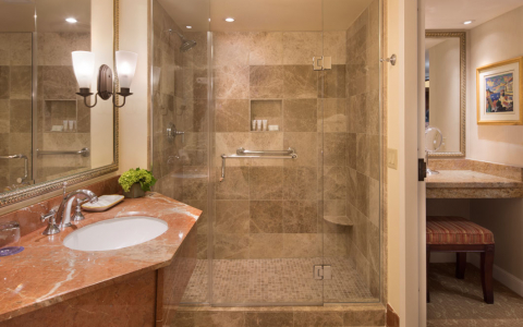 bathroom with granite countertop and marble shower