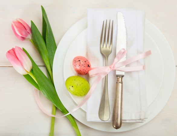 table setting with two white plates, for, knife, and pink tulips