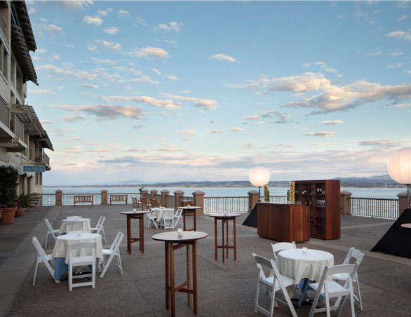 terrace overlooking the ocean set with cocktail tables