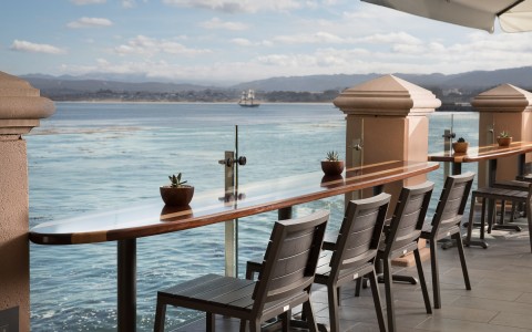 outdoor deck with bar seating overlooking water gallery 33