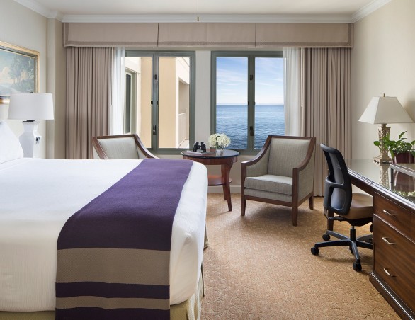 partial ocean view room with king bed and large picture windows