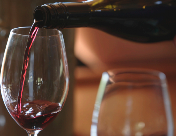 red wine being poured into a wine glass