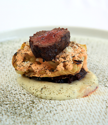 delicious looking food with sauce and steak on top
