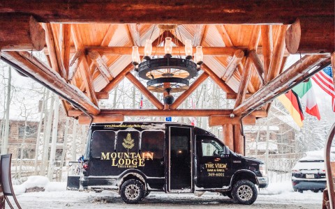a black van that has the mountain lodge and the view information on it
