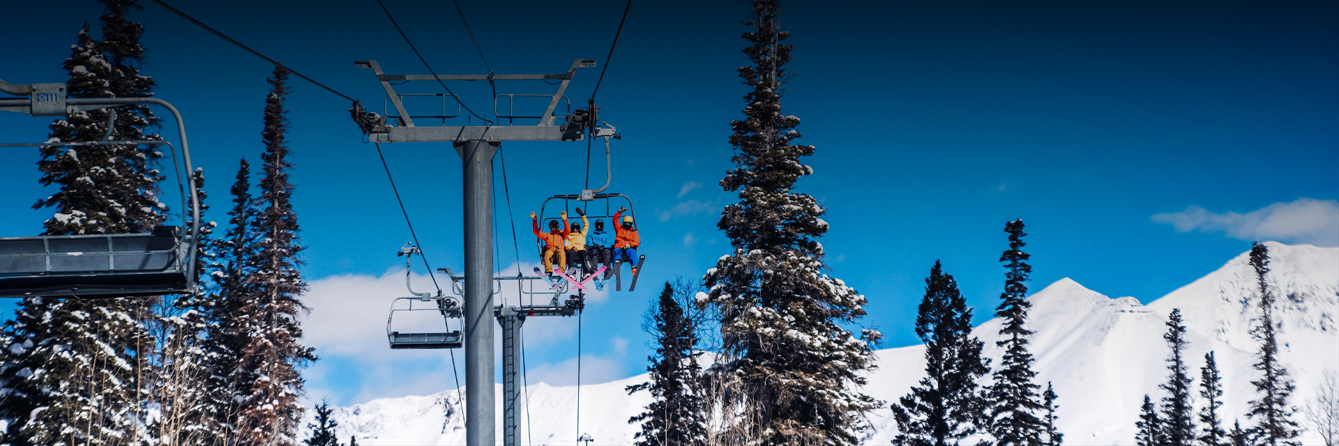 a zoomed out view of people on the ski lift during the day