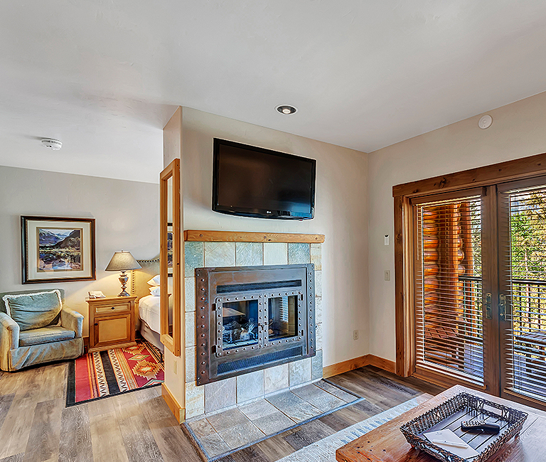 a suite with a fireplace and flat panel television 
