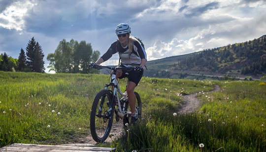 a person riding a mountain bike outdoors during the day