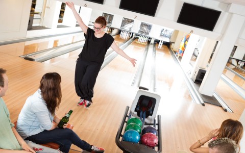 friends cheering and bowling