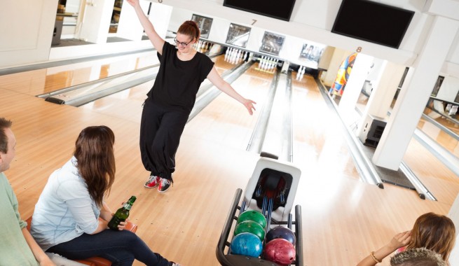 friends cheering and bowling