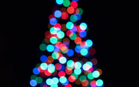 Out of focuse picture of christmas tree with multi colored lights
