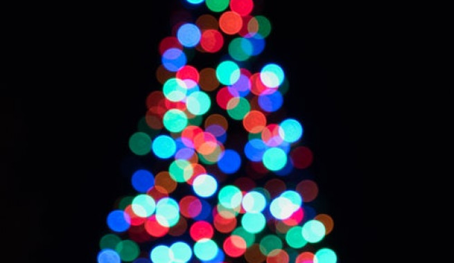 Out of focuse picture of christmas tree with multi colored lights