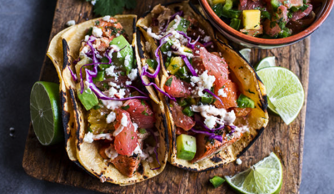 authentic Mexican tacos with lime wedges and side of salsa