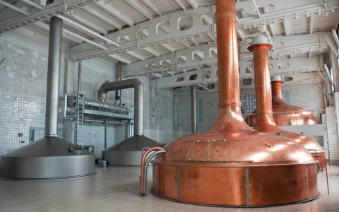 brewing production. large room with giant metal distillers