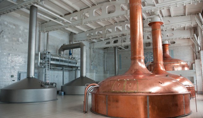 brewing production. large room with giant metal distillers