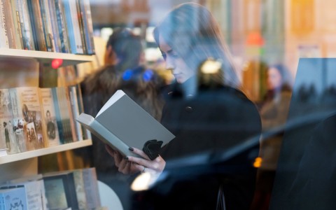 women reading a book in book store