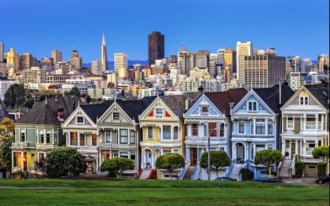 Row of colorful houses with the skyline in the background