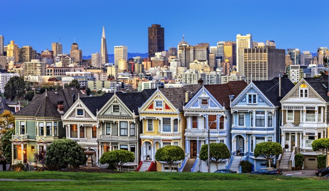 Row of colorful houses with the skyline in the background