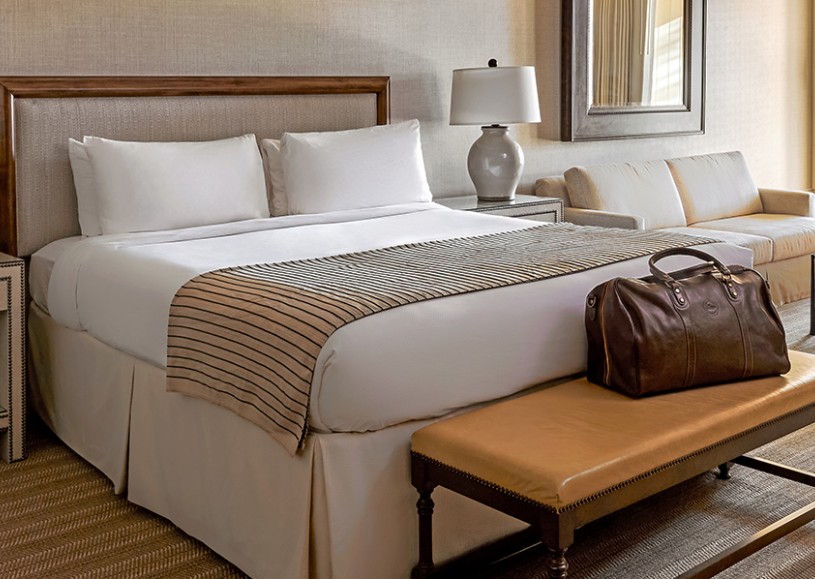 Internal view of a room with a large bed and a private balcony