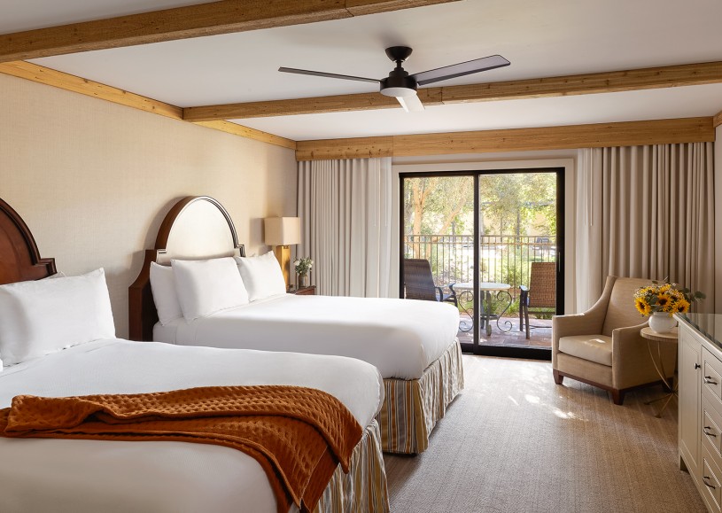 Internal view of a room with two white queen size beds
