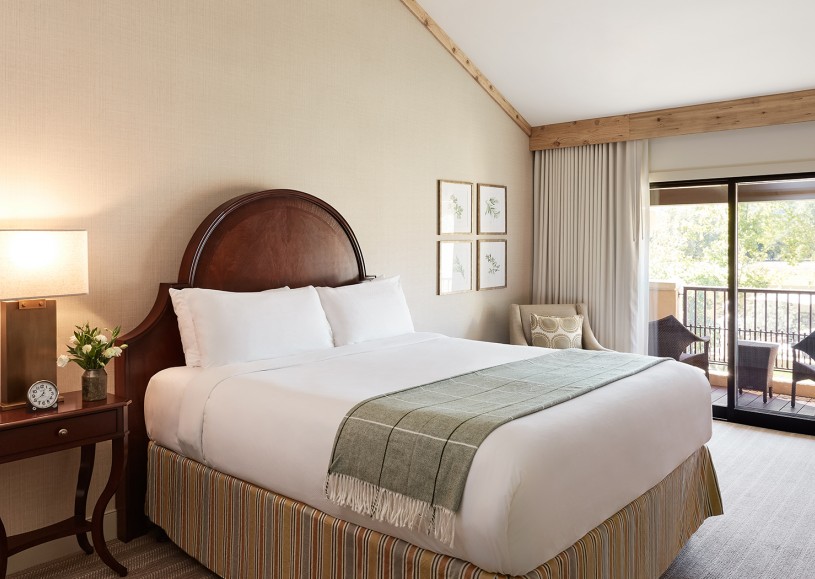 Internal view of a room with a large bed and a private balcony
