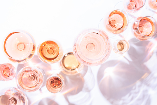 multiple wine glasses filled with rose
