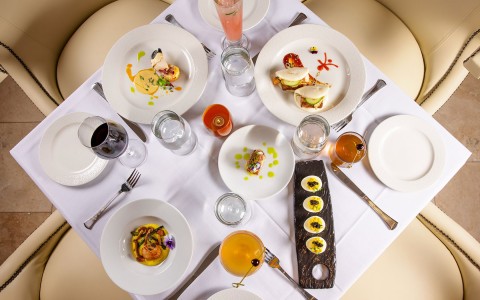 aerial view of a table with plates with food and glasses with drinks 